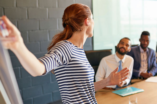 Woman collaborating with colleagues at a meeting - Hays Journal