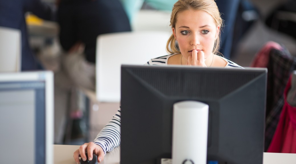 Employee at desk look at meeting request- Hays careers advice